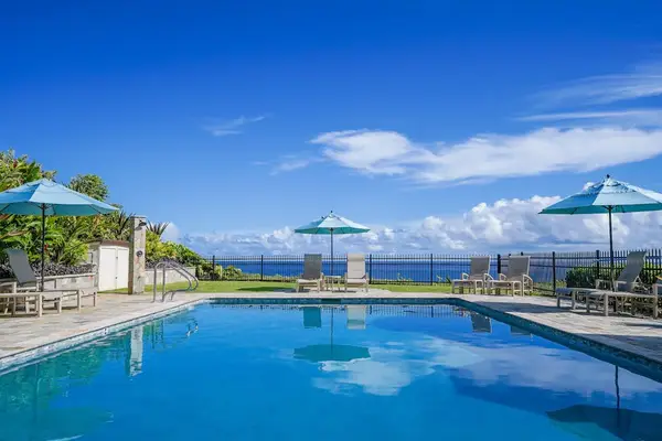 Pool area provides refreshing swims beside gardens and ocean