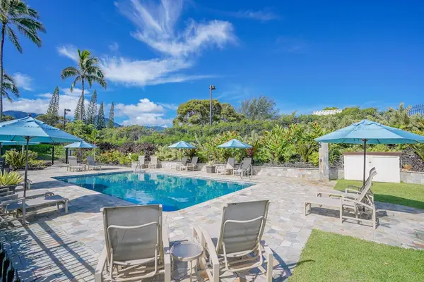 Poolside combines dining furniture, tropical landscaping, and clear waters