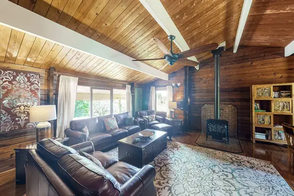 This home has an open-concept indoor living design with modern furnishings, vaulted ceilings, and even a gas fireplace for warming up on those high-elevation cool and damp volcano evenings.