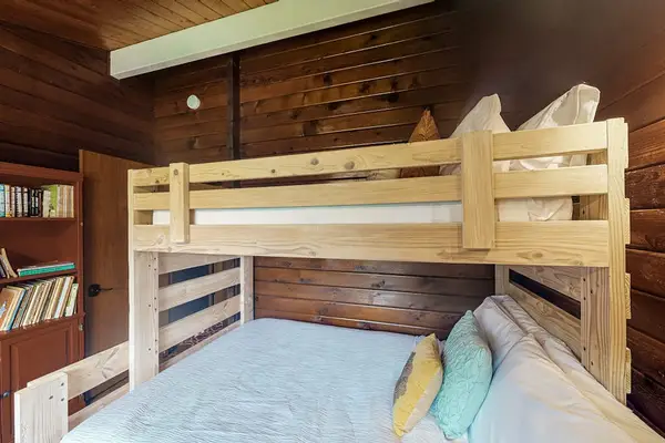 Guest room with bunk beds with a double and twin bed.