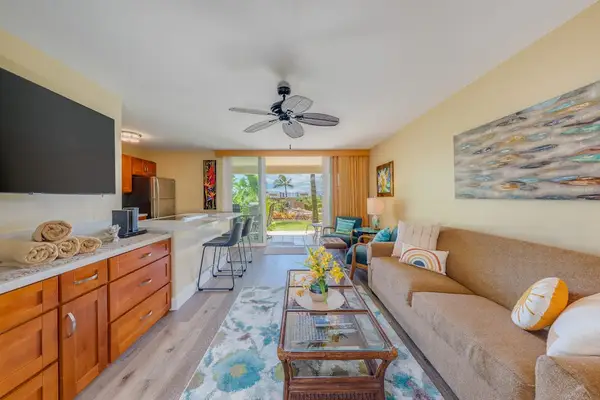 Bright living room with a large TV and easy access to the lanai.