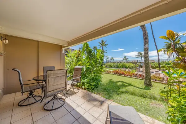 Relax on the covered lanai with comfortable seating and lush tropical surroundings.