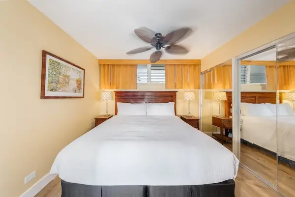 Comfortable bedroom with a king-size bed and ceiling fan for added comfort.