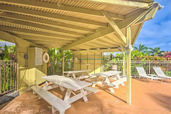Covered BBQ area with picnic tables for outdoor dining.