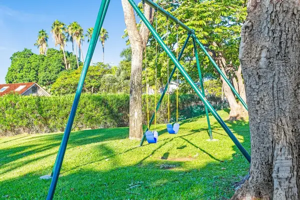 Little ones can enjoy the playground surrounded by lush tropical greenery.