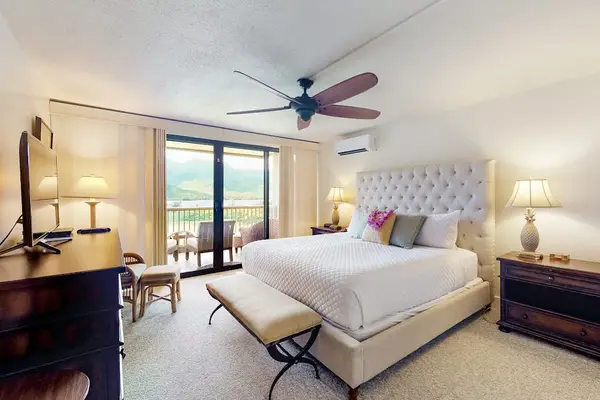 Recharge each night in this peaceful bedroom with outdoor views