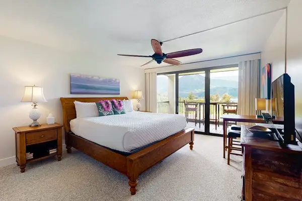 Rest peacefully in this bright bedroom with refreshing outdoor views