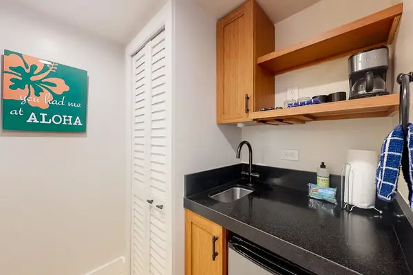 Kitchen includes cabinetry, coffee maker, and essentials