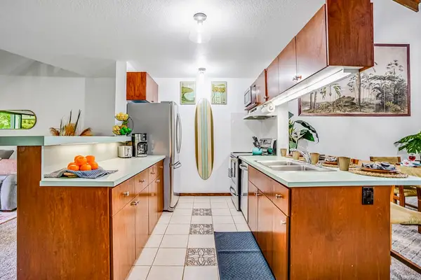Fully stocked kitchen with stainless steel appliances.
