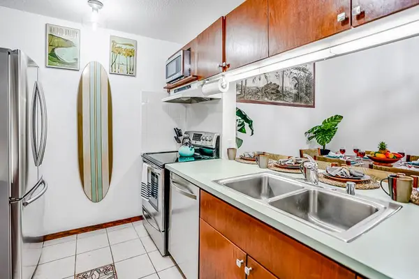 Fully stocked kitchen with stainless steel appliances.