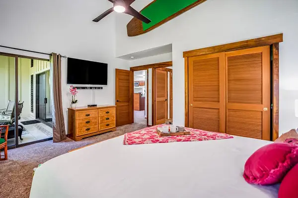 Master bedroom with king bed, private lanai access, flat screen tv and ensuite bathroom.