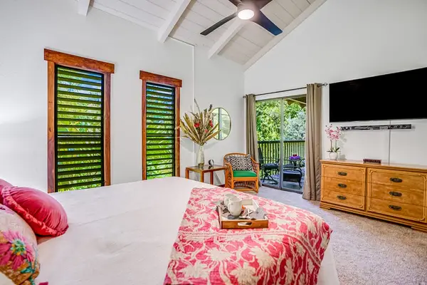 Master bedroom with king bed, private lanai access, flat screen tv and ensuite bathroom.