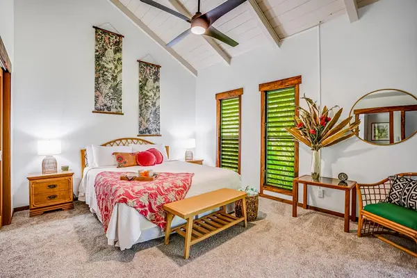 Master bedroom with king bed, private lanai access, flat screen tv and ensuite bathroom.