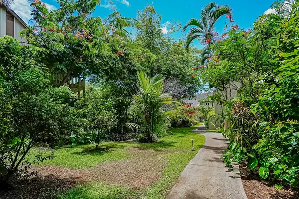 Waikomo Stream Villas Resort with lush tropical foliage.