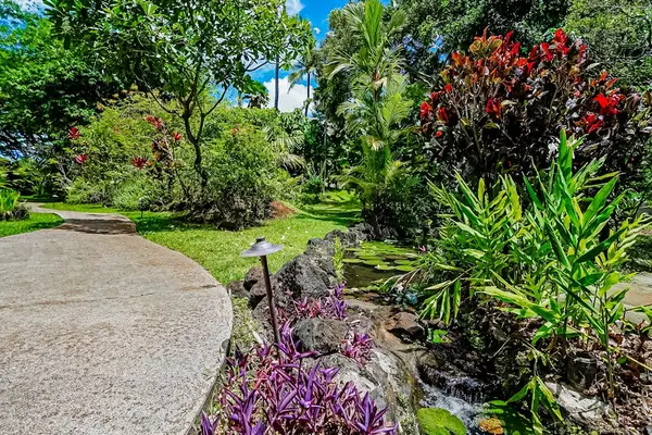 Waikomo Stream Villas Resort with lush tropical foliage.