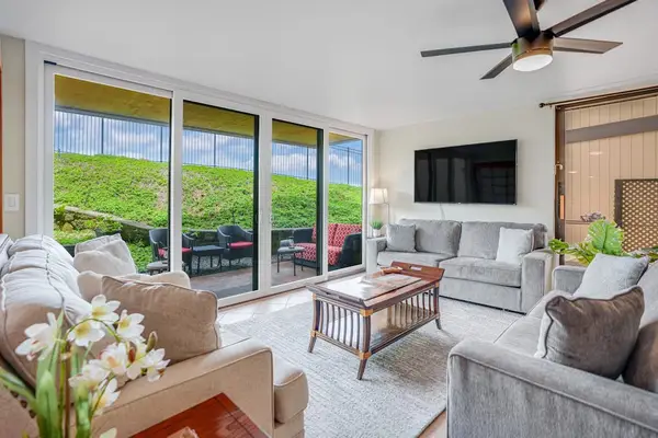 Bright, well-lit living room area with large television