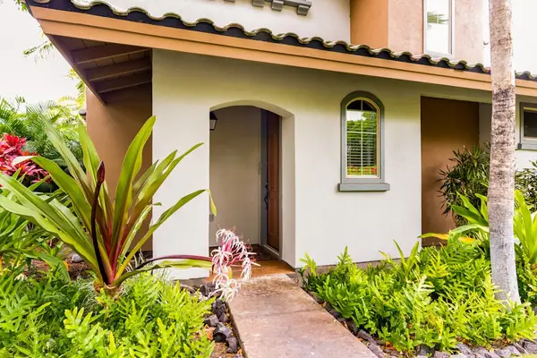 Charming Villa Entrance Surrounded By Lush Gardens