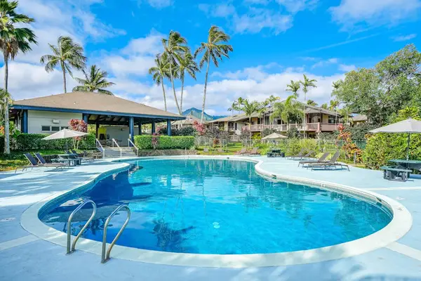 Sparkling pool invites sunny swims beside palms and tropical gardens