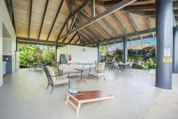 Covered patio lounge creates breezy shade for relaxing tropical afternoons