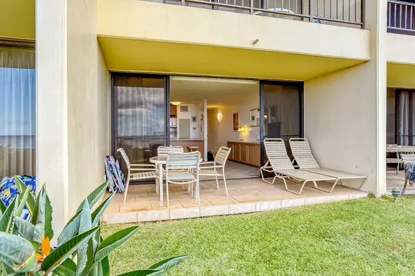 Ground-floor lanai opening to the tropical lawn