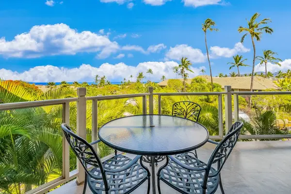 Covered Balcony Patio Featuring Outdoor Dining Set & Lush Tropical Scenery