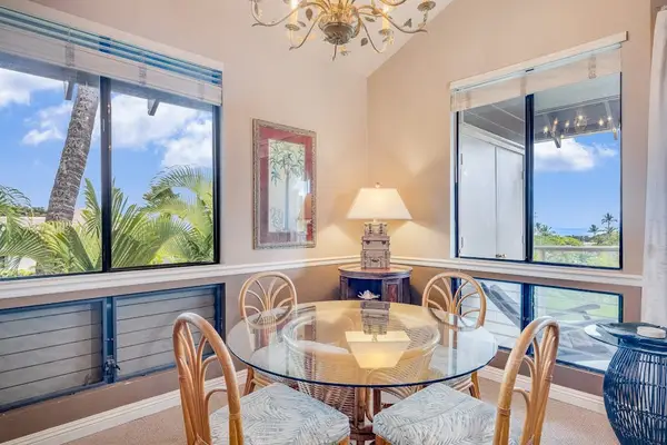 Sunlit Dining Nook with Glass-Top Table, Rattan Chairs & Ocean Views