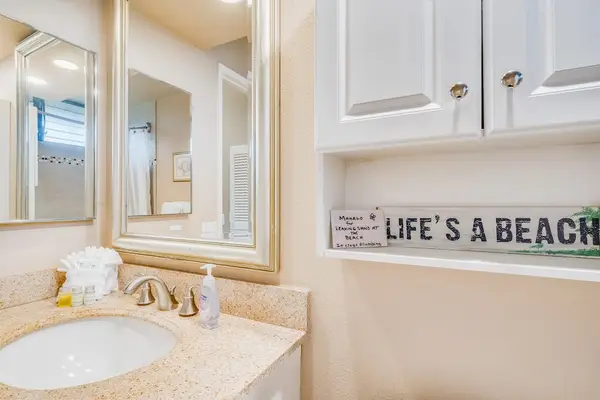Close-Up Vanity View Highlighted by Decorative "Life's a Beach" Wall Art