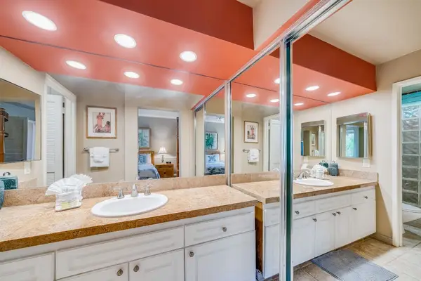 Wide View of Double Vanity Setup with White Cabinetry & Warm Accent Lighting