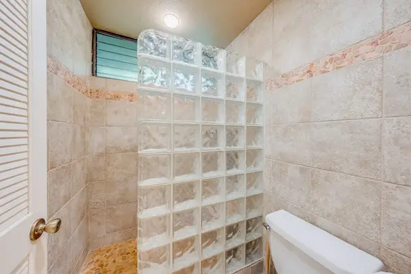 Walk-In Tile Shower Feature with Decorative Glass Block Partition