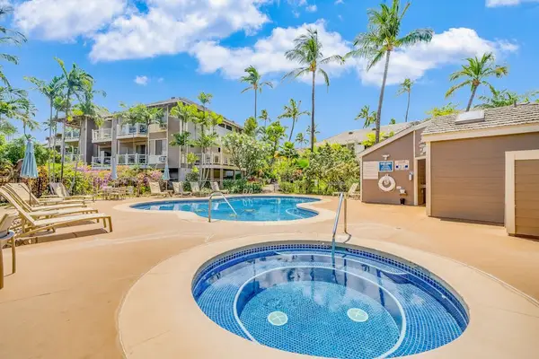 Resort Pool Deck featuring In-Ground Hot Tub & Poolside Loungers