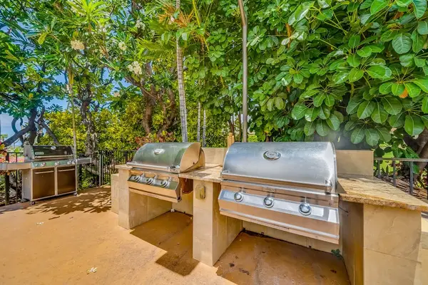Outdoor Stainless Steel BBQ Grilling Station set amid Tropical Foliage
