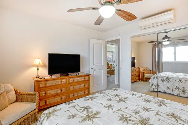 Guest bedroom with king bed, flat screen tv and large picture window.