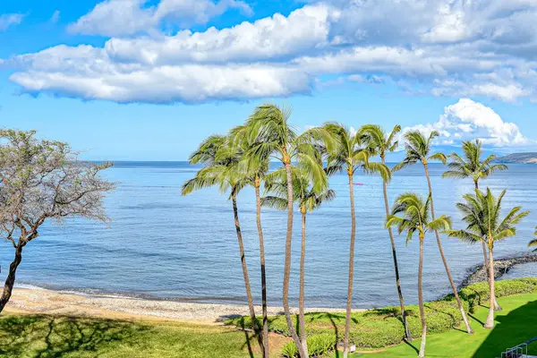 Perfectly manicured lawns with tropical foliage against the backdrop of the Pacific Ocean.