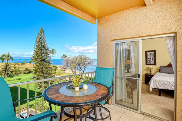 In the evening, dine alfresco as the sun sets over the ocean on your private lanai, featuring an outdoor table.