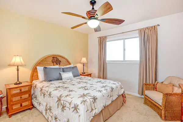 Guest bedroom with king bed and large picture window.