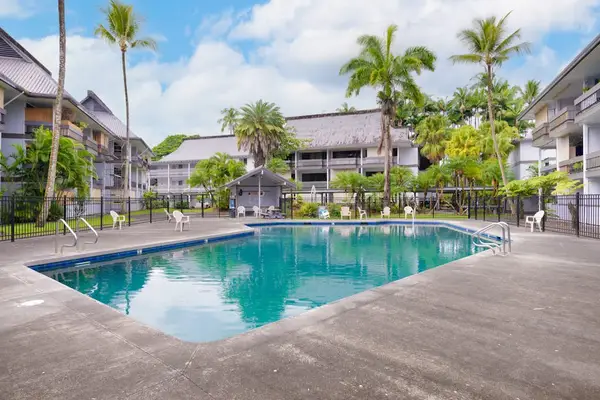 Inviting Resort Pool Surrounded By Tropical Beauty