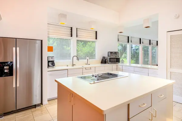 Gather in this inviting kitchen featuring scenic outdoor views and ample cooking space