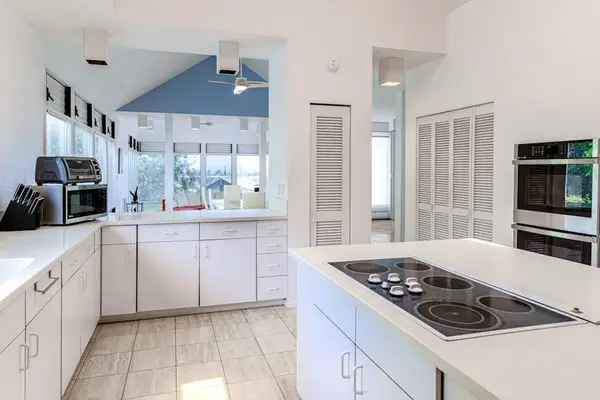 Fully equipped kitchen overlooks peaceful surroundings, creating an enjoyable cooking experience every day