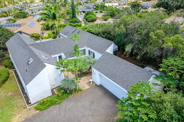 Admire this beautiful home from above featuring balcony and peaceful surrounding landscapes below