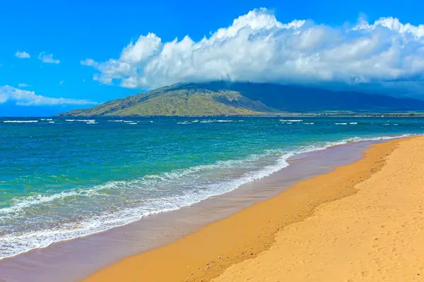 Crystal-clear turquoise waters gently wash onto pristine white sandy beaches.