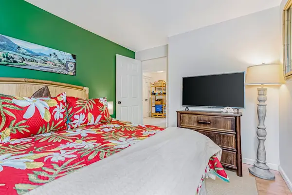 Guest bedroom with queen bed and flat screen tv.