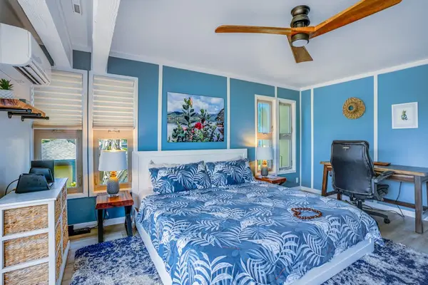 Master bedroom with king bed, flat screen tv, ceiling fan and access to your private lanai.