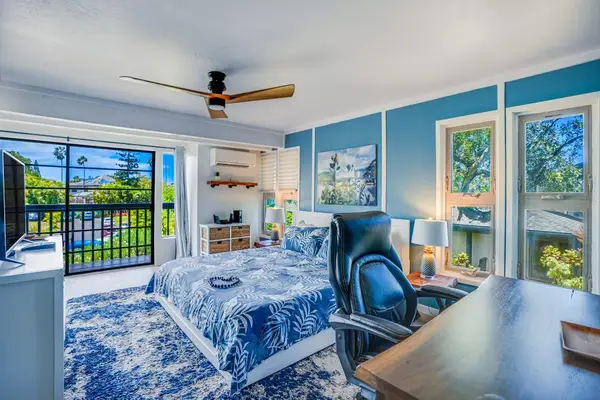 Master bedroom with private lanai access and flat screen tv for your enjoyment.
