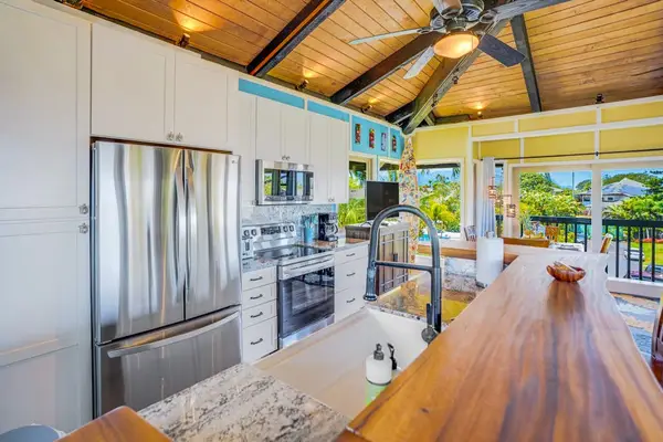 Completely remodeled stainless steel kitchen.   The island is for extra countertop space and barstools for extra seating.