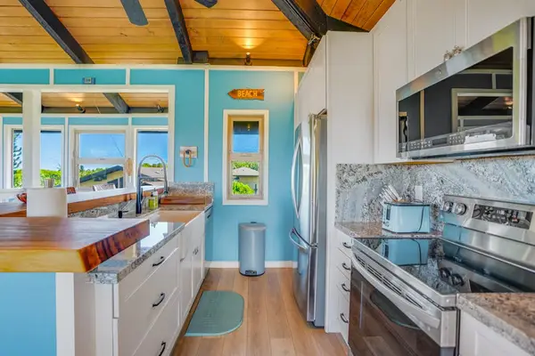 Completely remodeled stainless steel kitchen.   The island is for extra countertop space and barstools for extra seating.