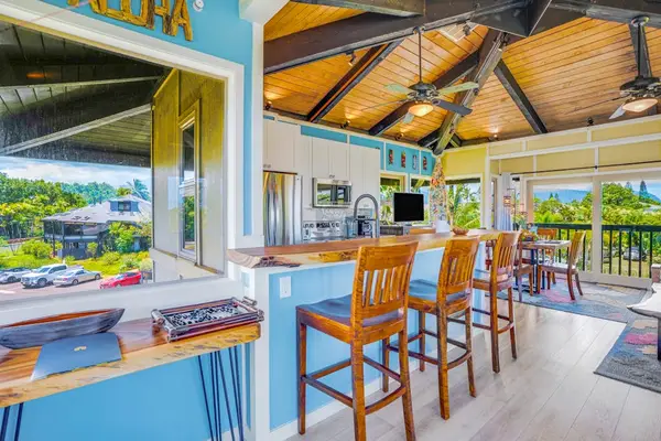 Completely remodeled stainless steel kitchen.   The island is for extra countertop space and barstools for extra seating.