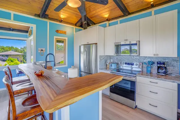 Completely remodeled stainless steel kitchen.   The island is for extra countertop space and barstools for extra seating.