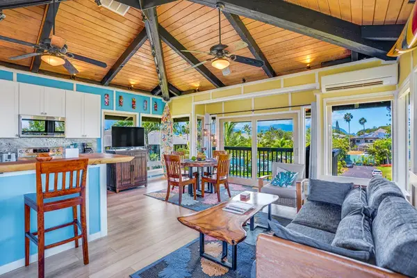 Living room with panoramic views comfortable seating and a flat screen tv.  In this open concept design with the kitchen, living room and dining room, you can always stay engaged with your guests.