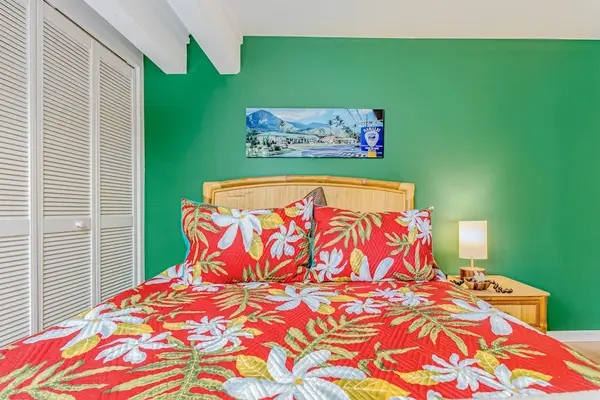 Guest bedroom with queen bed and flat screen tv.