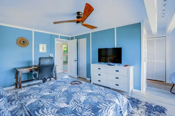 Master bedroom with king bed, flat screen tv and private lanai access.